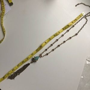 Long gold necklace with charm